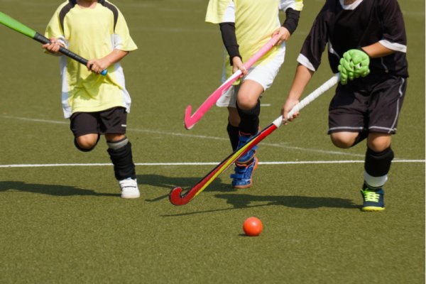 Children playing hockey to develop leadership skills Children playing hockey to develop leadership skills