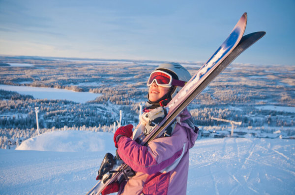School girl carrying skis School girl carrying skis