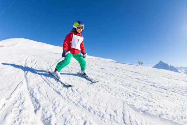 Young pupil skiing on school ski trip